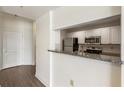 Compact kitchen features stainless steel appliances, granite counters, and white cabinets at 3475 Oak Valley Rd # 1850, Atlanta, GA 30326
