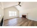 Bright living room featuring vaulted ceiling, fireplace, and large windows at 2192 Stenger Rd, Douglasville, GA 30135