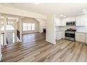 Open-concept living space with modern kitchen, fireplace, and beautiful flooring at 2192 Stenger Rd, Douglasville, GA 30135