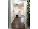 Bright entryway with hardwood floors, white wainscoting, and a door with sidelight windows at 3442 Old Towne Ln, Cumming, GA 30040