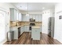 Modern kitchen features stainless steel appliances, an island, granite countertops, and light blue cabinets at 3442 Old Towne Ln, Cumming, GA 30040