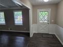 Inviting foyer features new laminate flooring, neutral paint, and decorative front door at 4015 Woodland Nw Dr, Kennesaw, GA 30152