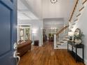 View into foyer featuring hardwood floors, staircase, and an open layout to the living and dining areas at 626 Kimberly Ne Ln, Atlanta, GA 30306
