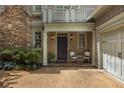Inviting front porch with seating area, charming architectural details, and a well-manicured garden at 626 Kimberly Ne Ln, Atlanta, GA 30306