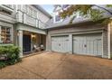 View of the front exterior with a two-car garage, a charming entryway with chairs, and manicured landscaping at 626 Kimberly Ne Ln, Atlanta, GA 30306