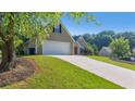 Long driveway leading to an attached garage on a well-maintained lot at 1625 Alcovy River Dr, Dacula, GA 30019