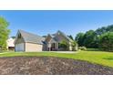Landscaped home with a large yard, attached garage, and inviting curb appeal at 1625 Alcovy River Dr, Dacula, GA 30019