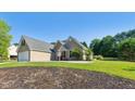 A wide view showcases the house's landscaped surroundings at 1625 Alcovy River Dr, Dacula, GA 30019