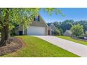 View of house with large driveway and attached garage at 1625 Alcovy River Dr, Dacula, GA 30019