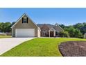 Well-maintained home with a spacious lawn and an attached two-car garage at 1625 Alcovy River Dr, Dacula, GA 30019