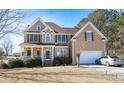 Charming home with lush lawn, a covered porch and two car garage at 190 Country Club Dr, Hiram, GA 30141