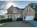 Inviting two-story home with a cozy porch and manicured landscaping at 190 Country Club Dr, Hiram, GA 30141