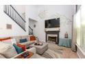 Bright and airy living room with a cozy fireplace, vaulted ceilings, and large windows at 190 Country Club Dr, Hiram, GA 30141