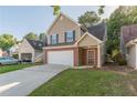 Two-story home featuring a brick-and-vinyl facade with an attached garage and a well-manicured front lawn at 1720 New Orleans Way, Mcdonough, GA 30252