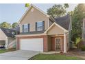 Two-story home featuring a brick-and-vinyl facade with an attached garage and a well-manicured front lawn at 1720 New Orleans Way, Mcdonough, GA 30252