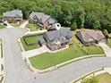 Aerial view of a home on a large corner lot in a quiet suburban neighborhood with mature trees at 2109 Cape Ivey Ct, Dacula, GA 30019
