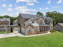 Beautiful two-story home featuring a two-car garage and lush green lawn on a sunny day at 2109 Cape Ivey Ct, Dacula, GA 30019