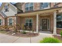 Inviting front porch with brick facade, cozy seating, and a welcoming entrance at 2109 Cape Ivey Ct, Dacula, GA 30019