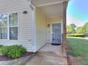 Inviting entrance with covered porch, a secure screen door and well-kept landscaping at 2326 Nicole Dr, Hampton, GA 30228