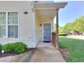 Inviting entrance with covered porch, a secure screen door and well-kept landscaping at 2326 Nicole Dr, Hampton, GA 30228