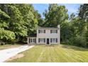 Charming two-story home with black shutters and a welcoming front yard surrounded by lush trees at 430 Pilgrim Ln, Powder Springs, GA 30127