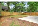 Spacious fenced backyard with a concrete slab, offering privacy and potential for outdoor activities at 73 Whitefoord Se Ave, Atlanta, GA 30317