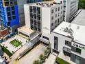 A bird's eye view of a condominium building highlighting its modern architecture and surrounding green space at 1421 Peachtree Ne St # 203, Atlanta, GA 30309