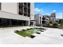 Exterior view of a condominium complex with water features, seating, and meticulous landscaping at 1421 Peachtree Ne St # 203, Atlanta, GA 30309