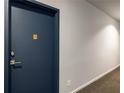 Hallway leads to unit door #203, with neutral paint, wall outlet and carpeted floor at 1421 Peachtree Ne St # 203, Atlanta, GA 30309