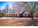 Captivating brick home with dormer windows, a covered porch, and a meticulously maintained front yard at 111 Dixson Rd, Bowdon, GA 30108