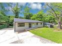 Inviting single-story home with a concrete driveway and a lush green lawn at 2317 Baywood Se Dr, Atlanta, GA 30315