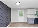 Modern kitchen with wood flooring and decorative gray paneled wall at 2317 Baywood Se Dr, Atlanta, GA 30315