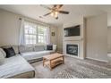 Comfortable living room featuring a fireplace, ceiling fan, and large sectional sofa at 331 Windcroft Nw Ln, Acworth, GA 30101