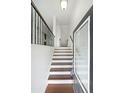 Welcoming entryway with hardwood floors, white walls, and wrought iron railing leading to the upper level at 3692 Lambert Ne Ln, Brookhaven, GA 30319