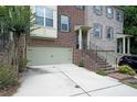 Attractive townhome with brick and siding exterior, featuring a two-car garage and well-maintained landscaping at 3692 Lambert Ne Ln, Brookhaven, GA 30319