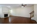Bright and spacious living room featuring hardwood floors, a fireplace, and a ceiling fan at 3692 Lambert Ne Ln, Brookhaven, GA 30319