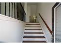 Elegant staircase with dark wood treads, white risers, and iron railing leads upstairs at 3692 Lambert Ne Ln, Brookhaven, GA 30319