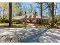 Charming brick home featuring a beautiful front lawn, mature trees, and a welcoming entrance at 9995 Huntcliff Trce, Atlanta, GA 30350
