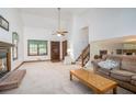 Spacious living room featuring a cozy fireplace, high ceilings, and an abundance of natural light at 1888 Kelvin Dr, Lawrenceville, GA 30043