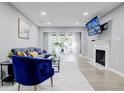 Cozy living room features a plush sofa, stylish blue chair, modern decor, and a fireplace at 24317 Plantation Ne Dr, Atlanta, GA 30324