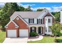 Beautiful two-story home with a brick and siding exterior, a well-maintained lawn, and a two-car garage at 3517 Ridgemill Cir, Dacula, GA 30019