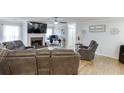 Spacious living room with hardwood floors, a fireplace, ceiling fan, and modern decor at 376 Paula Ct, Lawrenceville, GA 30046