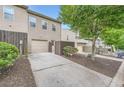 Townhome backyard with private driveway, detached garage, and mature trees at 3807 Cyrus Ridge Nw Way, Kennesaw, GA 30152