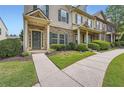 Inviting townhouse exterior with covered porch, brick facade, and meticulously maintained green spaces at 3807 Cyrus Ridge Nw Way, Kennesaw, GA 30152