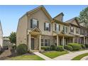 Attractive townhouse displaying brick and siding, a covered front porch, and tidy landscaping at 3807 Cyrus Ridge Nw Way, Kennesaw, GA 30152