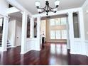 Inviting living room featuring hardwood floors, white columns, fireplace, and lots of natural light from large windows at 4056 Kingsley Park Ct, Peachtree Corners, GA 30096