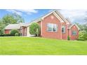 Well-maintained single-story brick home featuring a lush green lawn and tidy landscaping at 516 Main St, Hiram, GA 30141