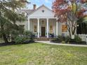 Inviting home exterior with a brick walkway leading to a classic columned front porch at 582 Lakeshore Ne Dr, Atlanta, GA 30307