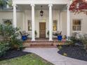 Detailed view of the home's elegant columned porch with brick accents and seating at 582 Lakeshore Ne Dr, Atlanta, GA 30307