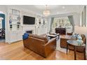 Bright living room featuring a fireplace, built-in bookshelves, and a comfortable brown leather sofa at 582 Lakeshore Ne Dr, Atlanta, GA 30307